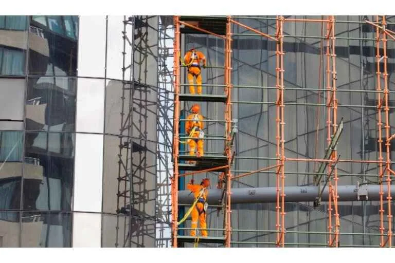 Men working on a tall building 