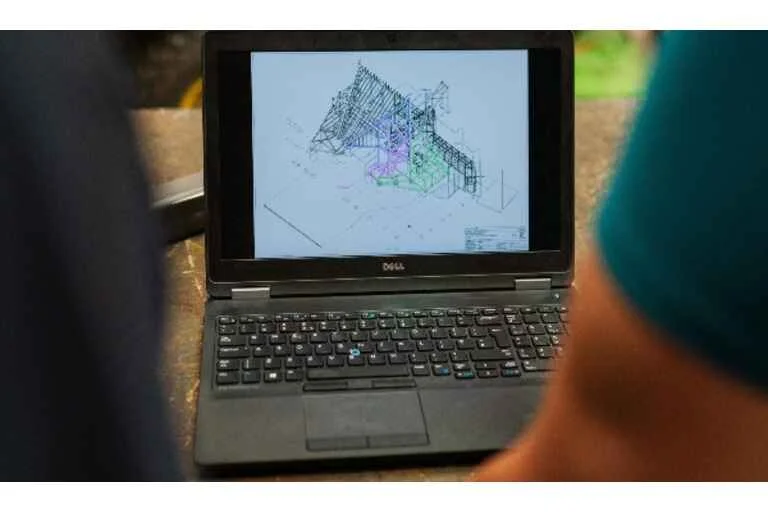 Laptop with designs onscreen. 