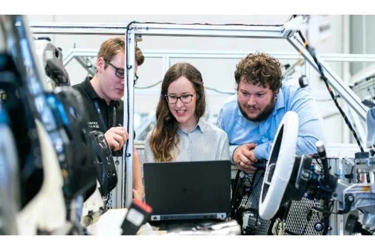 Employees working together on laptop