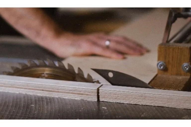 Person cutting wood with a circular saw