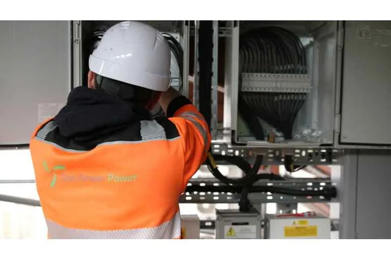 Geo Green Power employee working in an orange uniform and hard hat