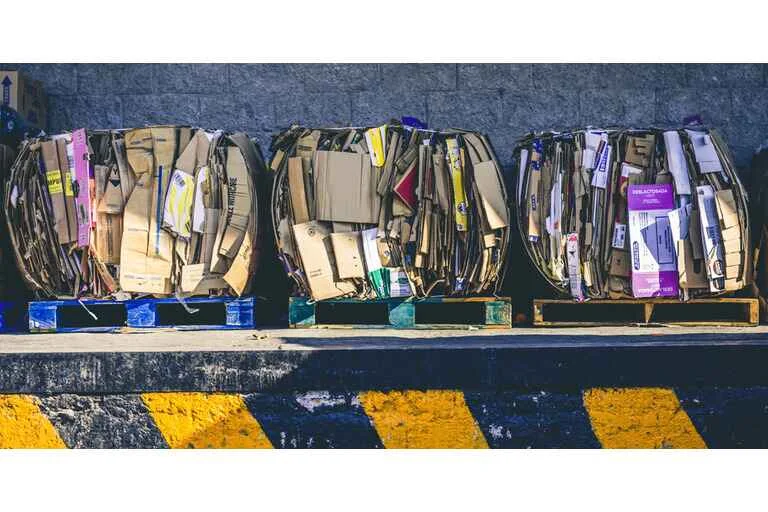 Flattened cardboard boxes on wooden pallets