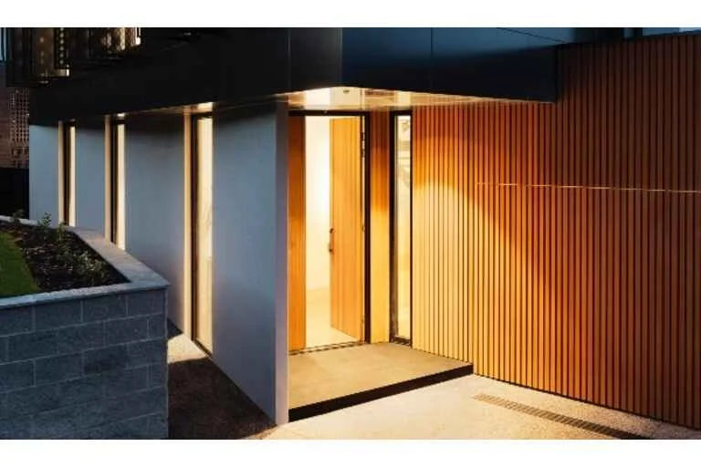 Outside of modern home with lights on inside