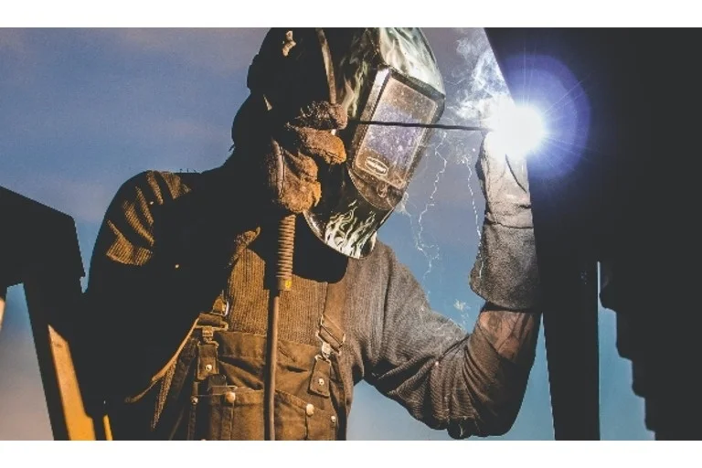 Man on ladder welding