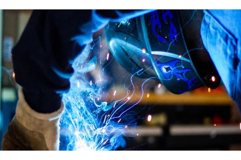 Man working surrounded by electricity beams