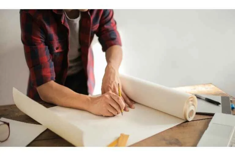 Man drawing on paper with a pencil