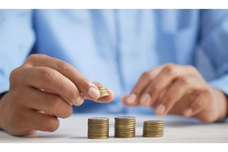 Person stacking coins