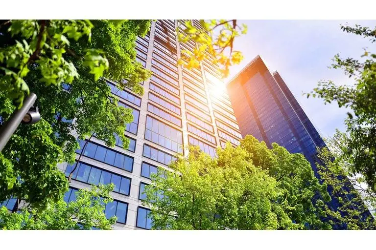 Fresh green trees and office building, business concept. Eco building in modern city concept.
