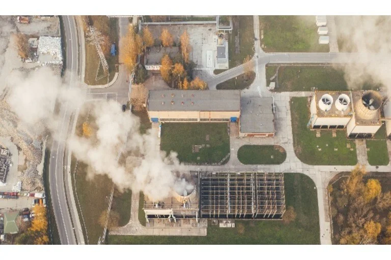 Aerial view of buildings with smoke coming from chimney