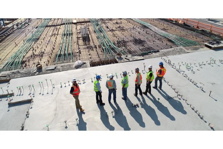 Construction workers at a construction site wearing hi-vis and hard hats