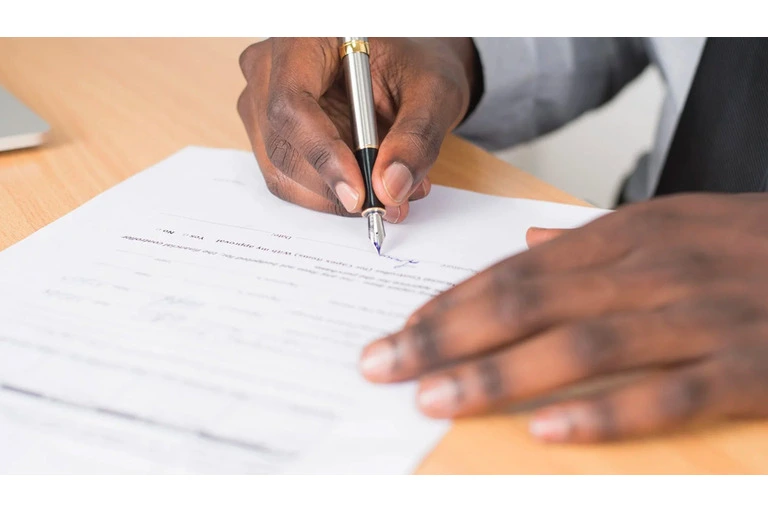 Man writing a subcontractor agreement