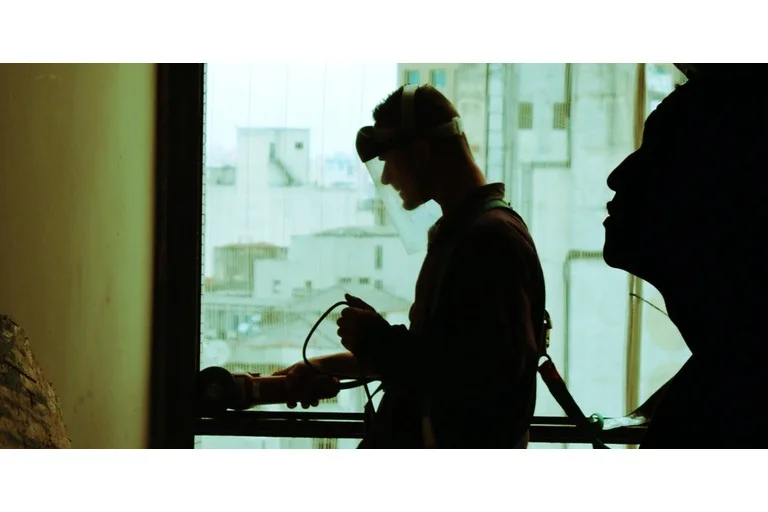 Employee working, wearing a safety face shield